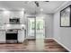 Updated kitchen boasting stainless appliances, white cabinets, granite countertops, and new wood flooring at 243 Woodview Ln, Smyrna, GA 30082