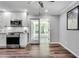 Well-lit kitchen featuring stainless steel appliances, white cabinets, and a sunroom view at 243 Woodview Ln, Smyrna, GA 30082