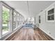 Bright sunroom with cushioned wicker furniture and views of the back yard at 243 Woodview Ln, Smyrna, GA 30082