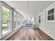 Enclosed sunroom features lots of natural light, neutral paint, and light woodgrain flooring at 243 Woodview Ln, Smyrna, GA 30082