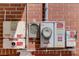 Photovoltaic Solar electrical utility boxes mounted on brick wall at 243 Woodview Ln, Smyrna, GA 30082