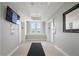 Hallway with elevators, large windows, TV, and decorative mirror at 2479 Peachtree Ne Rd # 1801, Atlanta, GA 30305