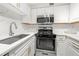 Modern white kitchen featuring stainless steel appliances, white quartz countertops, and ample storage at 2479 Peachtree Ne Rd # 1801, Atlanta, GA 30305