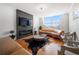 Stylish living room boasts hardwood floors, modern fireplace, comfortable seating, and expansive windows at 2479 Peachtree Ne Rd # 1801, Atlanta, GA 30305