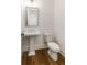 Bathroom with pedestal sink, toilet, and wood-look floors at 6790 Encore Blvd, Sandy Springs, GA 30328