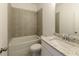Tiled bathroom featuring a tub and shower combination and granite countertop at 6790 Encore Blvd, Sandy Springs, GA 30328