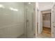 Modern bathroom featuring a glass-enclosed shower with gray tile and a glimpse into an organized closet at 6790 Encore Blvd, Sandy Springs, GA 30328