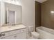 Bright bathroom features a granite-topped vanity, a large mirror, and a bathtub with stylish tile surround at 6790 Encore Blvd, Sandy Springs, GA 30328