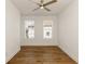 Bright bedroom features hardwood floors, a ceiling fan, and large windows that bring in natural light at 6790 Encore Blvd, Sandy Springs, GA 30328