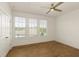 Minimalist bedroom with hardwood floors, three windows with blinds, and white walls at 6790 Encore Blvd, Sandy Springs, GA 30328