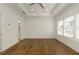 Bright and airy bedroom featuring hardwood floors, tray ceilings, and large windows, offering a serene living space at 6790 Encore Blvd, Sandy Springs, GA 30328