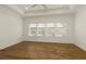 Spacious bedroom with hardwood floors, tray ceiling, and large windows offering ample natural light and a calming atmosphere at 6790 Encore Blvd, Sandy Springs, GA 30328