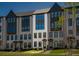 Stylish brick townhome showcases symmetrical design with multiple windows and manicured front lawn at 6790 Encore Blvd, Sandy Springs, GA 30328