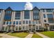 Charming townhome featuring a light brick facade, multiple windows and well maintained landscaping at 6790 Encore Blvd, Sandy Springs, GA 30328