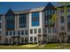 Charming townhome featuring a brick facade, dark trim, and manicured lawn at 6790 Encore Blvd, Sandy Springs, GA 30328