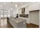 Bright kitchen showcasing a large center island, white cabinets, and modern fixtures at 6790 Encore Blvd, Sandy Springs, GA 30328