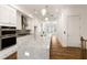 Well-lit kitchen featuring an island, ample counter space, and hardwood flooring at 6790 Encore Blvd, Sandy Springs, GA 30328