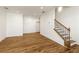 Spacious living room with wood floors, a staircase with wood and iron railings, and ample natural light at 6790 Encore Blvd, Sandy Springs, GA 30328