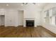 Spacious living room with a fireplace, ceiling fan, and large windows at 6790 Encore Blvd, Sandy Springs, GA 30328