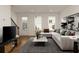 Cozy living room with modern decor, plush seating, a stylish coffee table, and a staircase at 6790 Encore Blvd, Sandy Springs, GA 30328