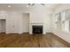 Spacious living room featuring hardwood floors, a modern fireplace, and ample natural light at 6790 Encore Blvd, Sandy Springs, GA 30328