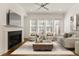 Cozy living room features a fireplace, ceiling fan, and lots of natural light at 6790 Encore Blvd, Sandy Springs, GA 30328