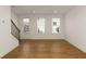 Bright living room featuring hardwood floors and large windows that invite natural light at 6790 Encore Blvd, Sandy Springs, GA 30328