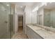 Main bathroom featuring double vanity, walk-in closet, and glass shower at 6790 Encore Blvd, Sandy Springs, GA 30328
