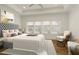 Spacious main bedroom with large bed, sitting area, and window at 6790 Encore Blvd, Sandy Springs, GA 30328