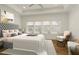 Well-lit main bedroom featuring tray ceiling, large windows, carpet, and stylish furniture at 6790 Encore Blvd, Sandy Springs, GA 30328