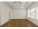 Large, bright main bedroom with wood floors and a view to the main bathroom at 6790 Encore Blvd, Sandy Springs, GA 30328