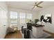 Home office features a ceiling fan, a large window, and modern desk setup with unique artistic decorations at 6790 Encore Blvd, Sandy Springs, GA 30328