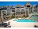 Aria community pool featuring lounge chairs, tables and chairs, and brick exteriors at 6790 Encore Blvd, Sandy Springs, GA 30328