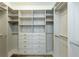 Spacious walk-in closet with custom shelving and drawers for organized storage at 6790 Encore Blvd, Sandy Springs, GA 30328