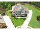 Stunning aerial view of a luxurious home featuring manicured lawns and a sprawling driveway at 859 Heritage Lake Way, Grayson, GA 30017