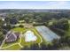 An aerial view shows the community pool, tennis courts, clubhouse, and surrounding wooded area at 859 Heritage Lake Way, Grayson, GA 30017