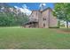 Home's backyard featuring a large lawn, walk out patio and spacious deck at 859 Heritage Lake Way, Grayson, GA 30017