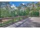 View of the backyard deck and the surrounding mature trees and lawn at 859 Heritage Lake Way, Grayson, GA 30017