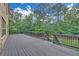 The backyard deck features dark railings, an open design and mature trees in the background at 859 Heritage Lake Way, Grayson, GA 30017