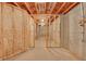 Unfinished basement with wood framing and insulation, offering a blank canvas for customization and future development at 859 Heritage Lake Way, Grayson, GA 30017