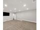 Spacious carpeted basement features recessed lights, neutral walls and trim, with access to another room at 859 Heritage Lake Way, Grayson, GA 30017