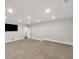 Large basement with recessed lighting and a TV mounted on the wall at 859 Heritage Lake Way, Grayson, GA 30017