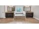 Luxurious bathroom boasts double vanities, soaking tub, and granite countertops at 859 Heritage Lake Way, Grayson, GA 30017