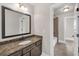 Stylish bathroom boasts granite countertop, tile floor, and large vanity mirror at 859 Heritage Lake Way, Grayson, GA 30017