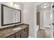 Stylish bathroom featuring granite countertop and large framed mirror at 859 Heritage Lake Way, Grayson, GA 30017