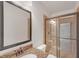 Bathroom features granite countertop, a walk-in shower with glass doors, and tiled walls at 859 Heritage Lake Way, Grayson, GA 30017