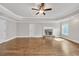 Inviting bedroom with hardwood floors, a cozy fireplace, and a ceiling fan at 859 Heritage Lake Way, Grayson, GA 30017