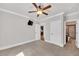 Carpeted bedroom features a ceiling fan, neutral walls and trim, with an adjoining bathroom and closet at 859 Heritage Lake Way, Grayson, GA 30017