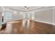Spacious bedroom featuring hardwood floors, a ceiling fan, tray ceiling and large windows at 859 Heritage Lake Way, Grayson, GA 30017