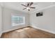 Bedroom featuring hardwood floors, ceiling fan, window, and TV at 859 Heritage Lake Way, Grayson, GA 30017